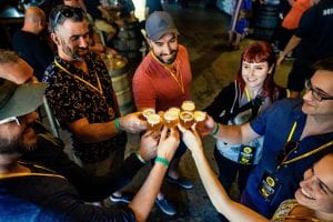 A group of tour guests toast with City Brew Tours